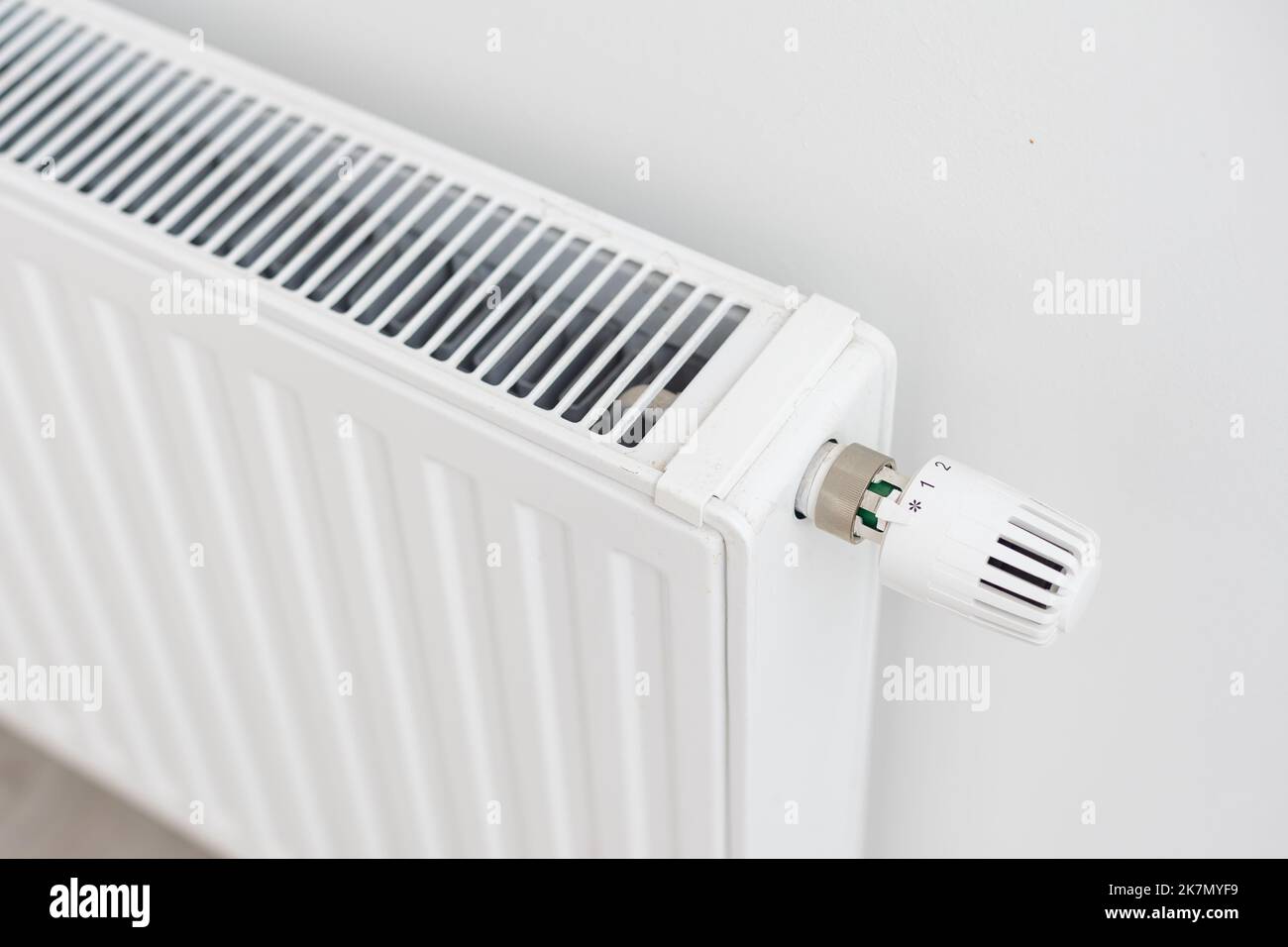 White radiator with temperature control valve. Central heating battery ...