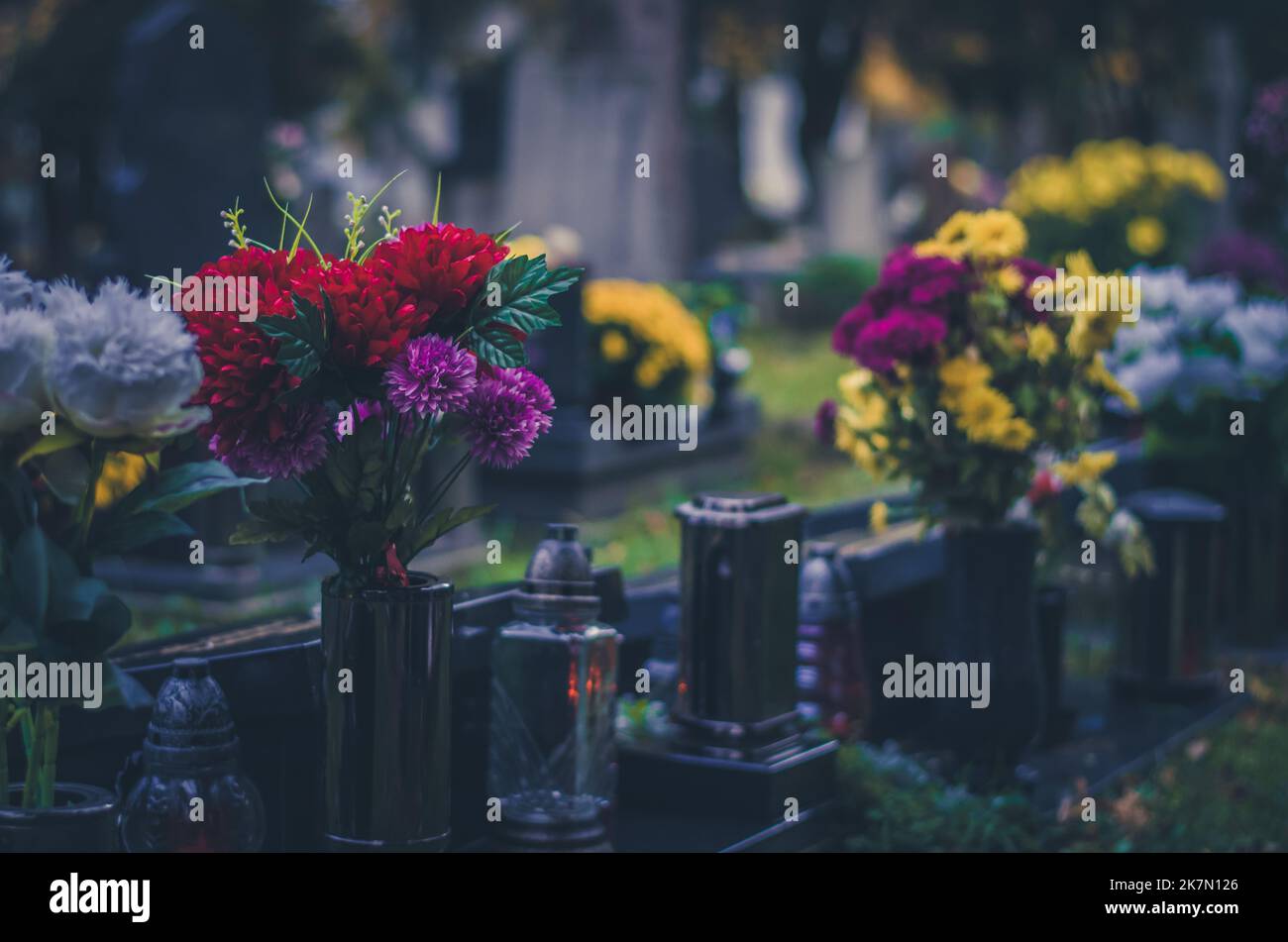graves with flowers, decorations and candles backgrounds during all