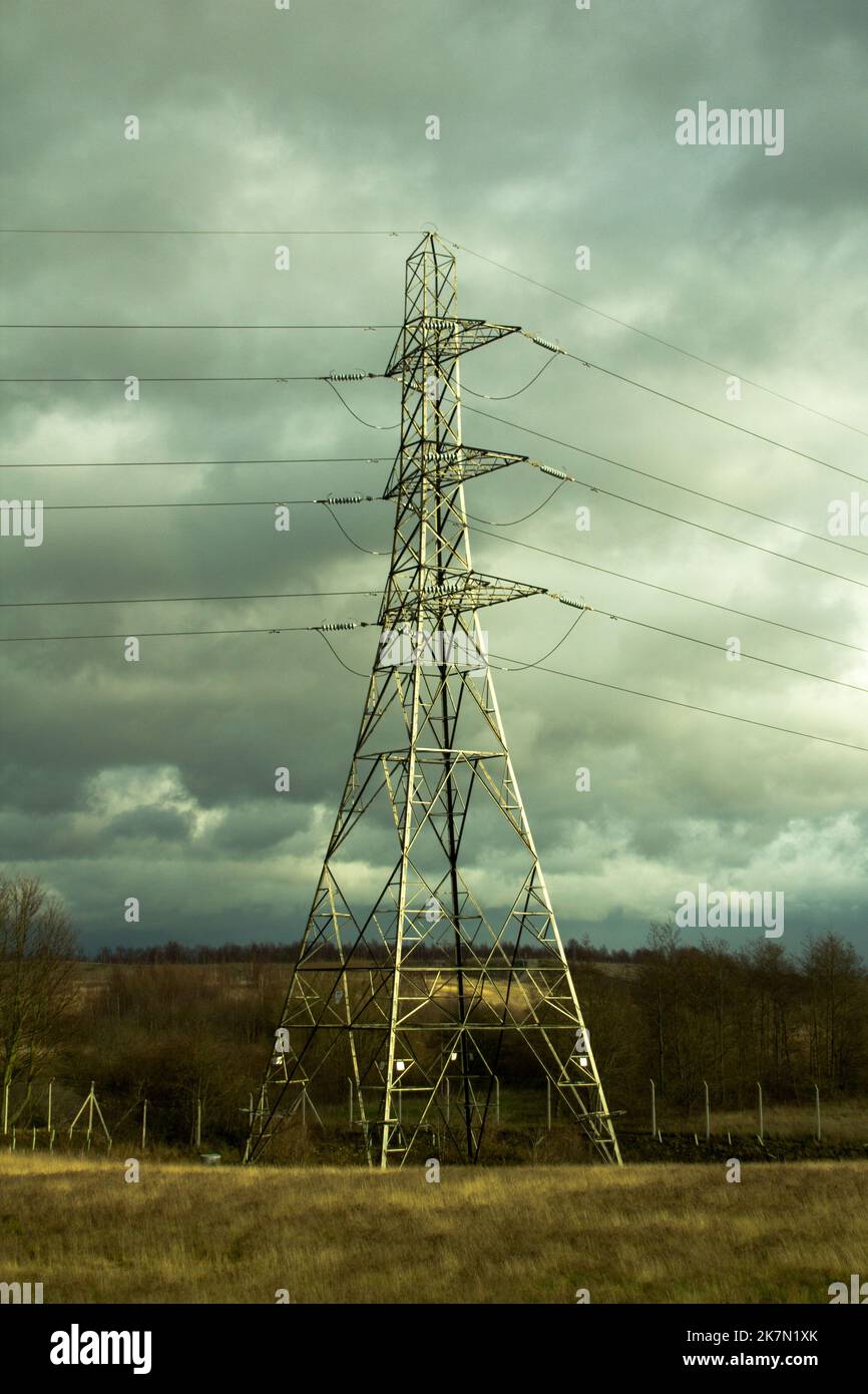 The vertical view of a Transmission tower under the cloudy sky Stock ...