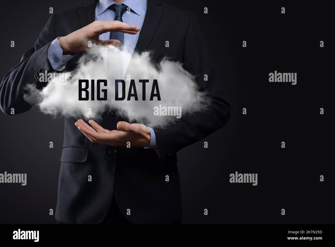 Hand showing a cloud with the words big data on dark background Stock Photo