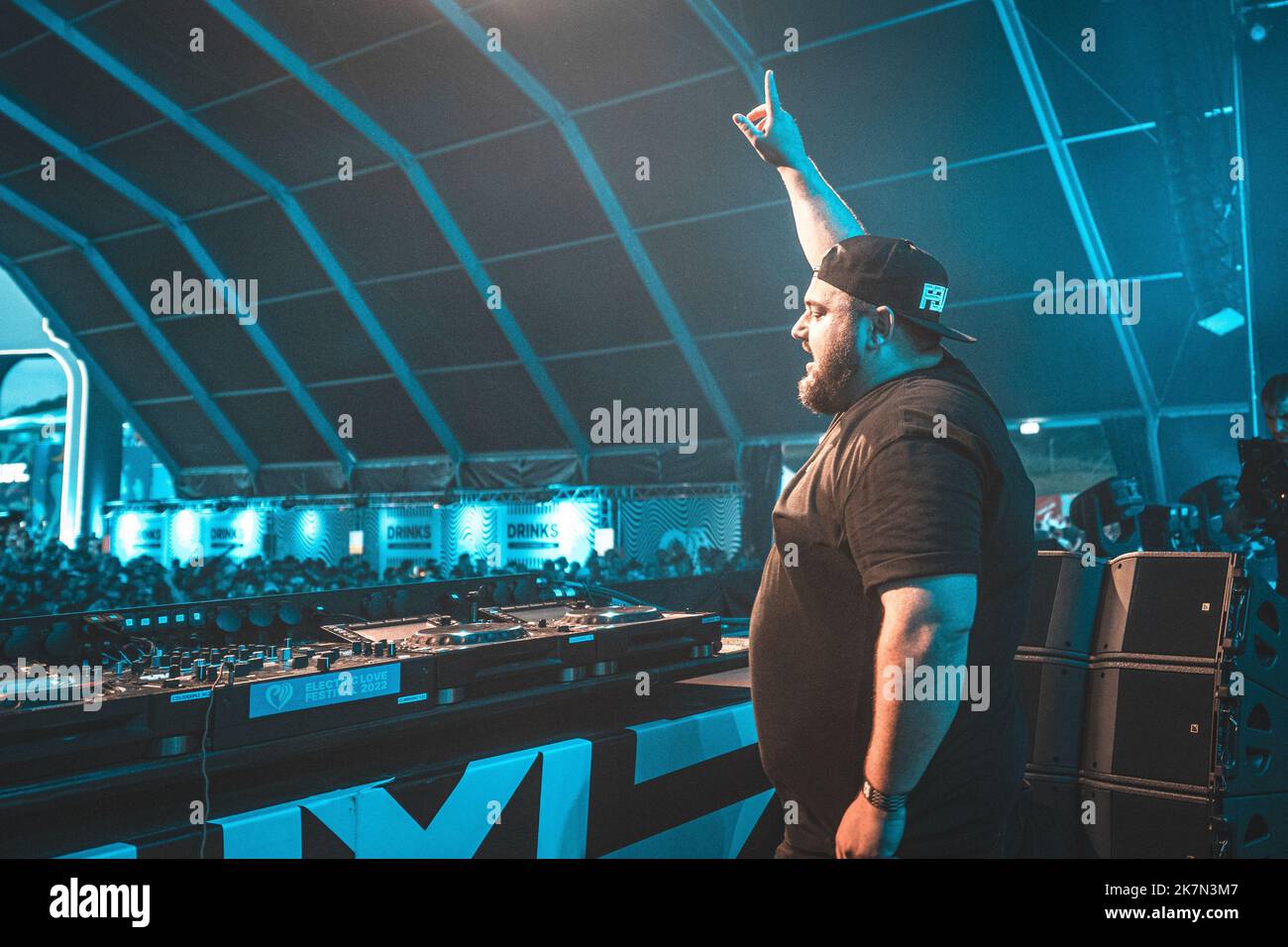 A male DJ with his arm up at "Electric Love Festival" 2022 in Austria
