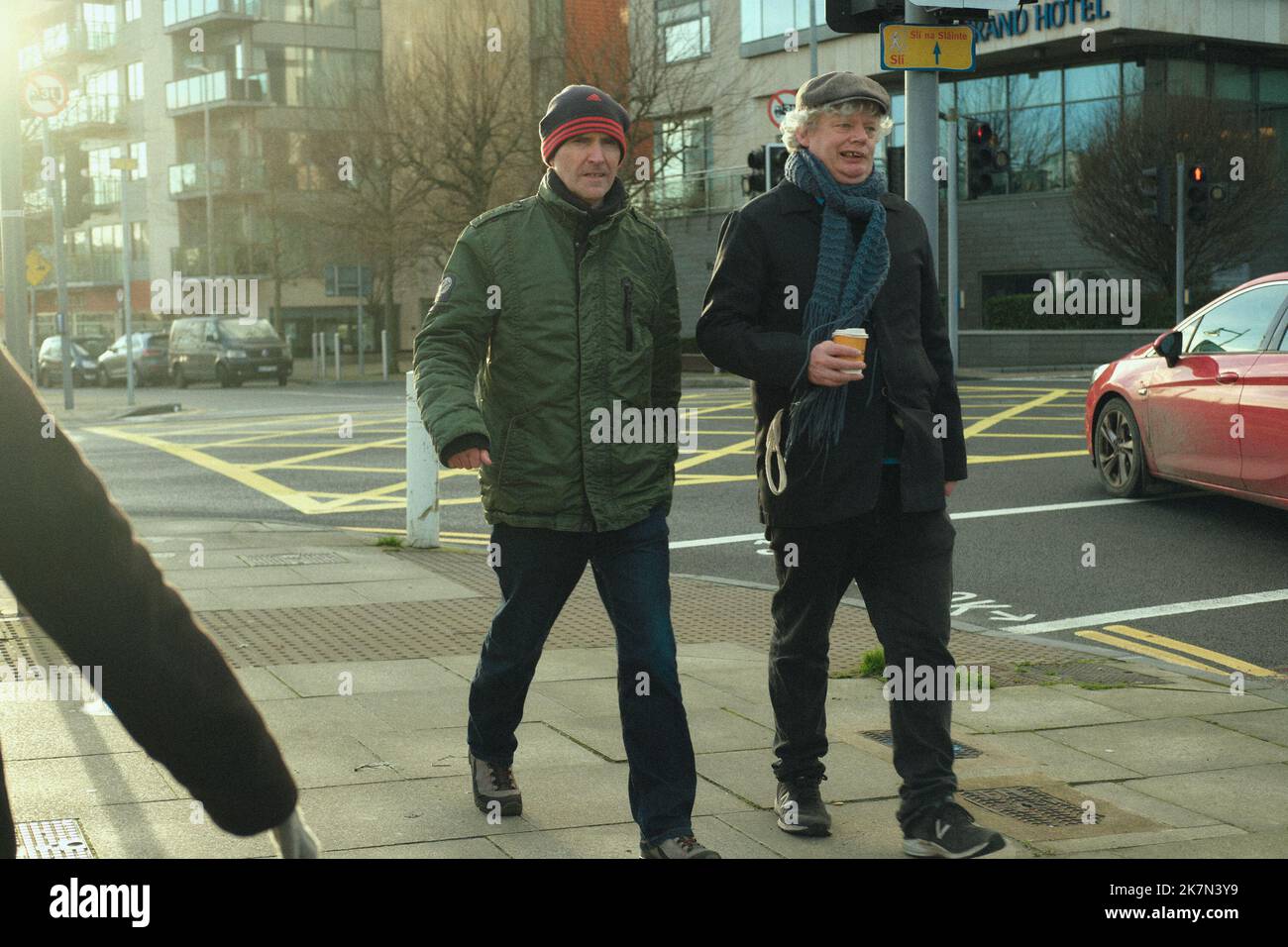 Two Irish males in winter coats walking on the streets of Limerick in Irland Stock Photo