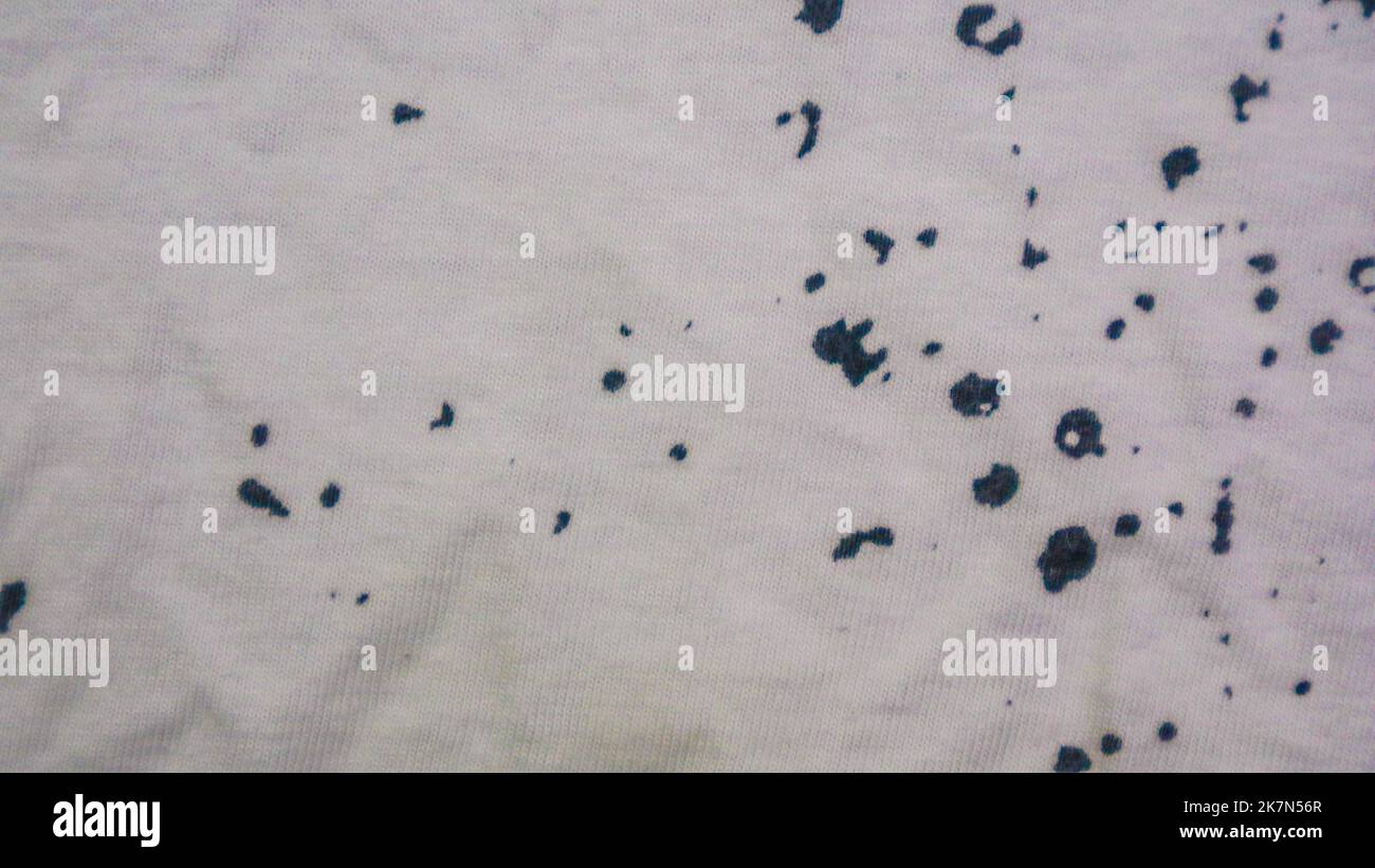 White cloth texture with black spots as background Stock Photo