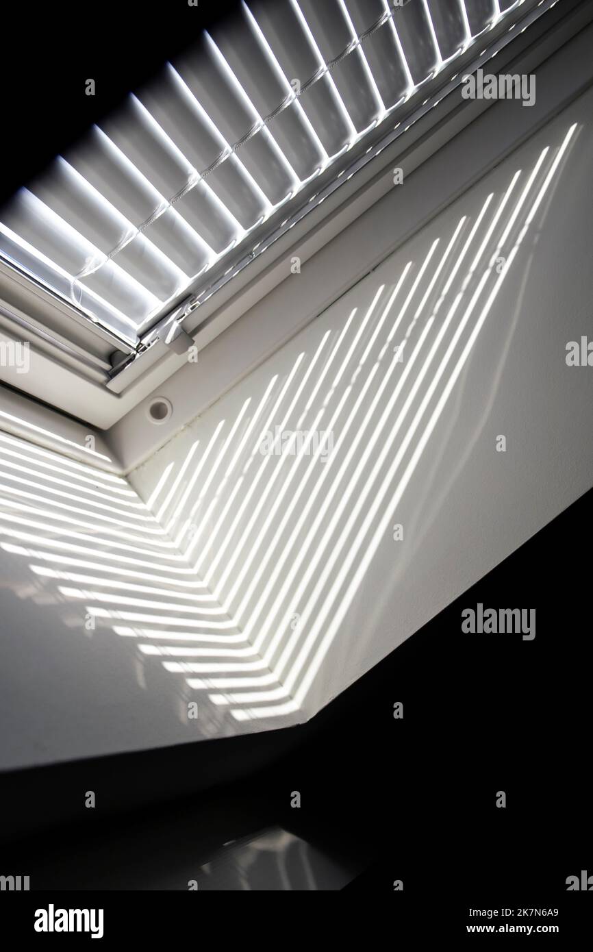 A close up portrait of a velux roof window with a closed jalousie in it