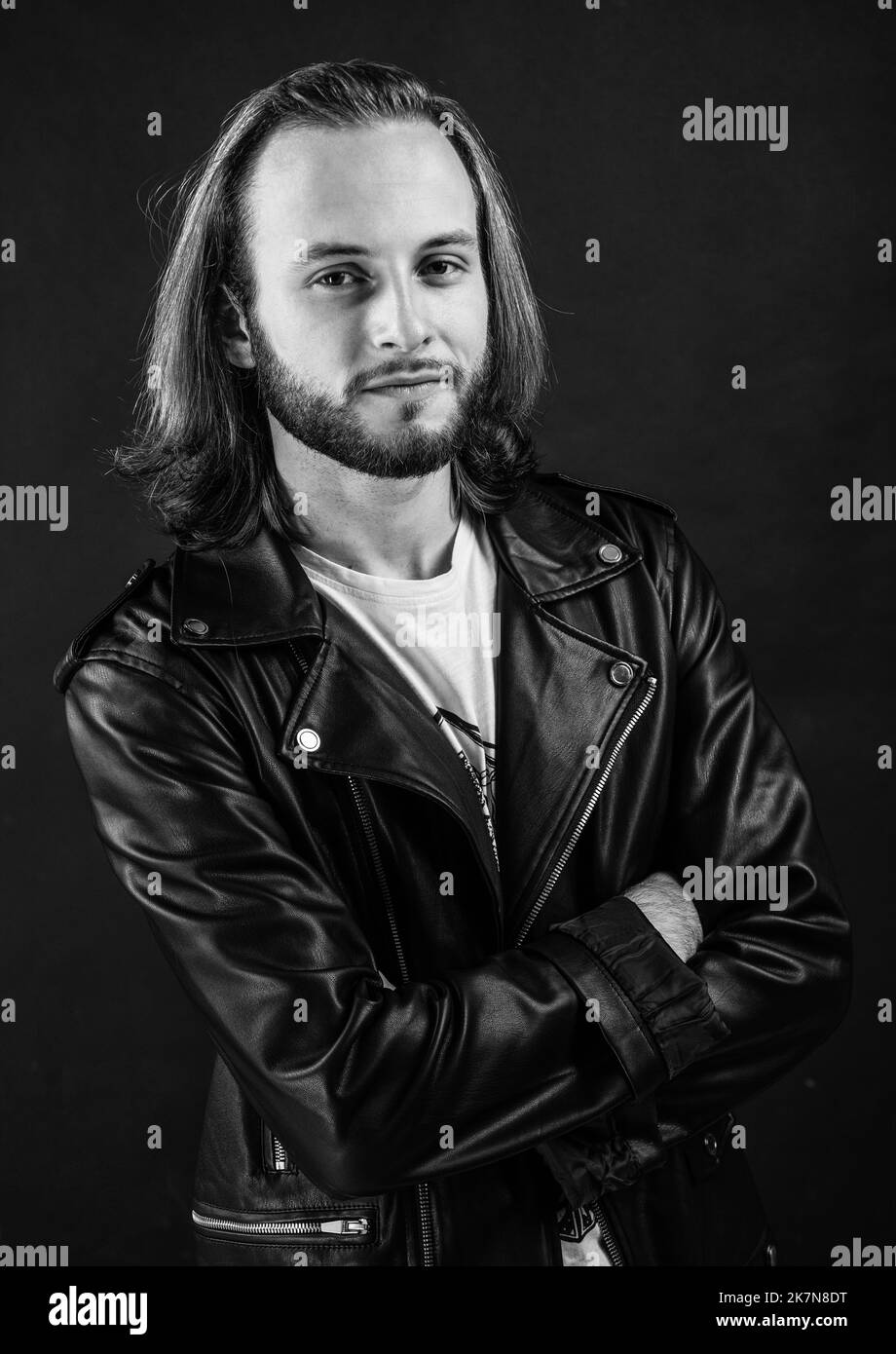 bearded rocker in leather jacket. man with long hair. rock style