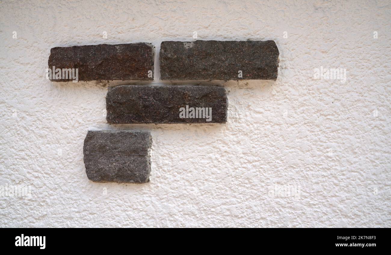 Stone wall with decorative stones and facings Stock Photo