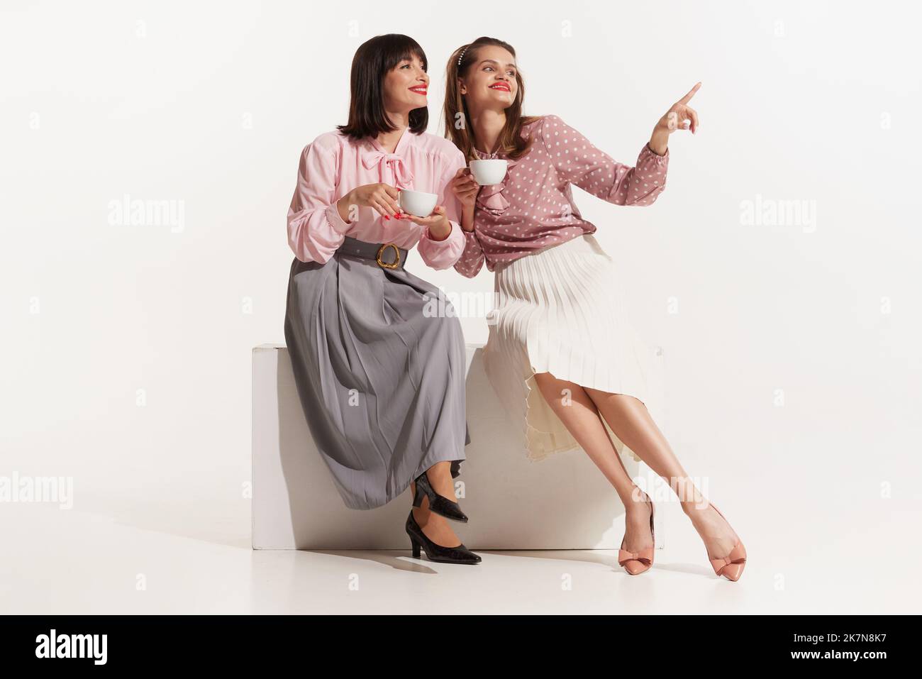 Pretty Young Girls In Retro 70S, 80S, 90S Fashion Style, Outfits Isolated  Over White Studio Background. Concept Of Eras Comparison, Beauty, Vintage  Stock Photo - Alamy
