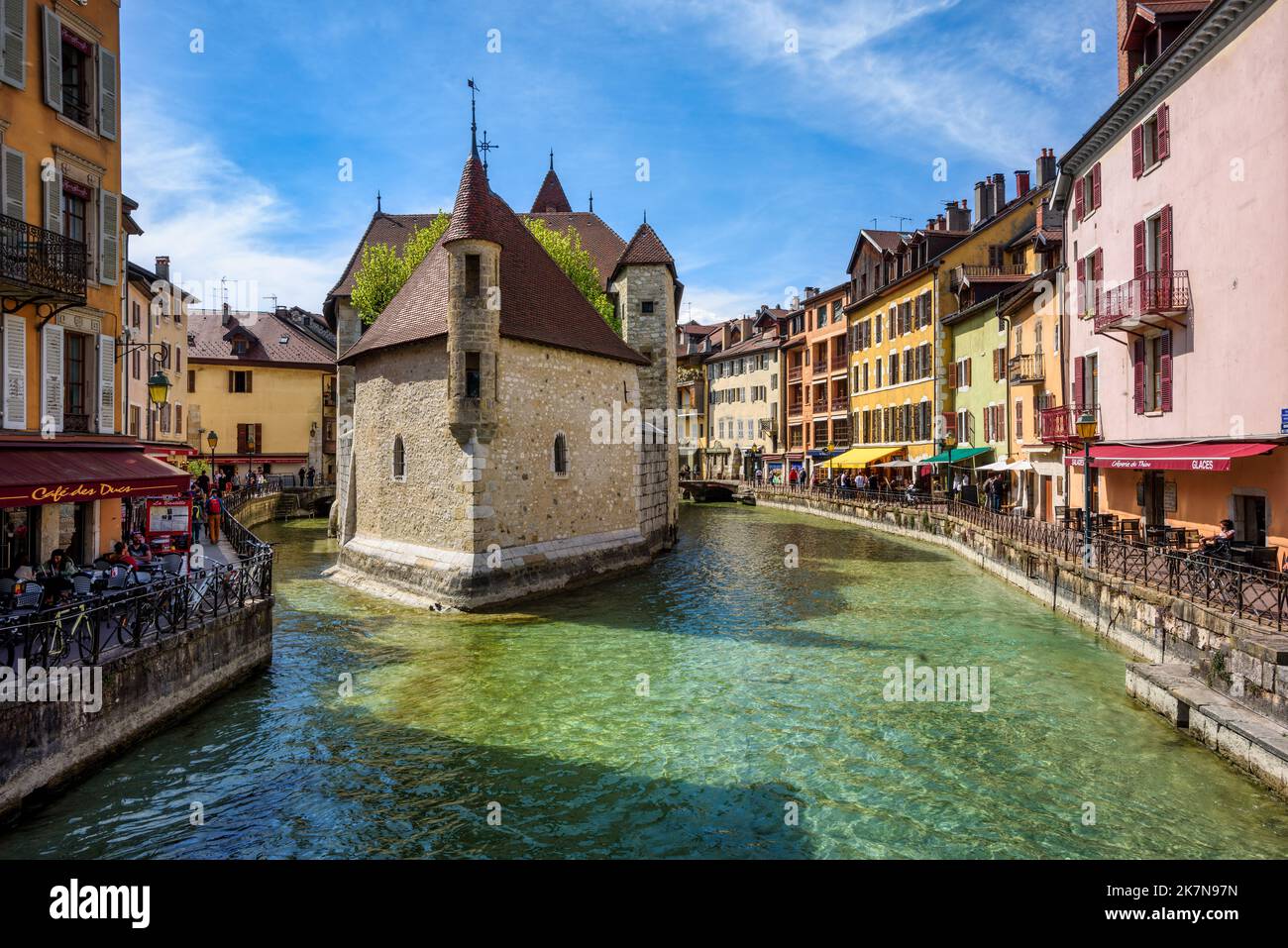 Annecy, France - 19 April 2022: Palais de l’Isle, a medieval stone house on river Thiou, is the main landmark and a popular tourist attraction in Anne Stock Photo