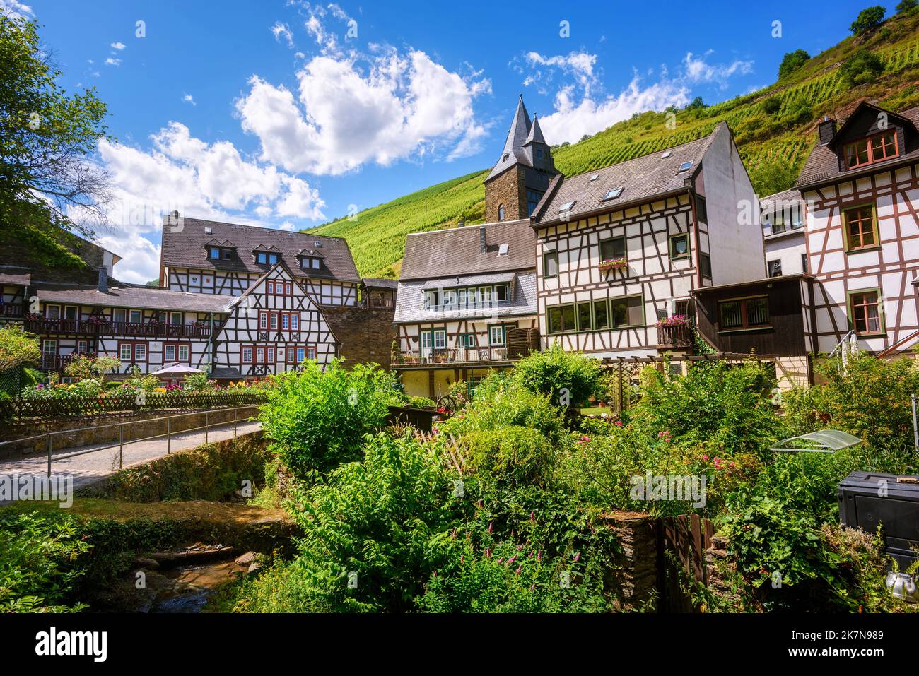 White half-timbered houses amid the vineyard hills in historical Bacharach town, Germany, a romantic small town in Rhine river valley Stock Photo