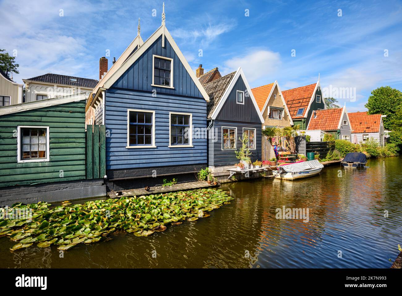 Traditional wooden colorful waterside houses in De Rijp village