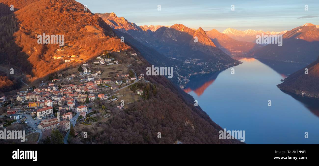 Panoramic sunset view of Lake Lugano and Monte Bre in swiss Alps mountains on the border of Switzerland and Italy Stock Photo