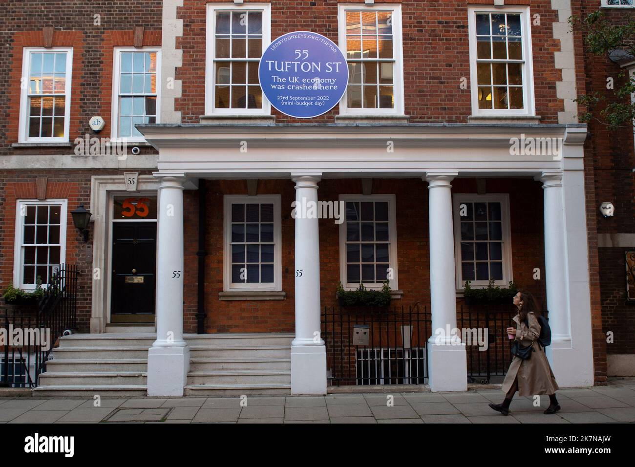 London, UK, 18 October 2022. A woman walks past 55 Tufton Street in Westminster, where campaigners from Led By Donkeys fixed a blue plaque. The building is home to several free market groups that were instrumental in Kwarsi Kwarteng's mini budget. Credit: David Mirzoeff/Alamy Live News Stock Photo