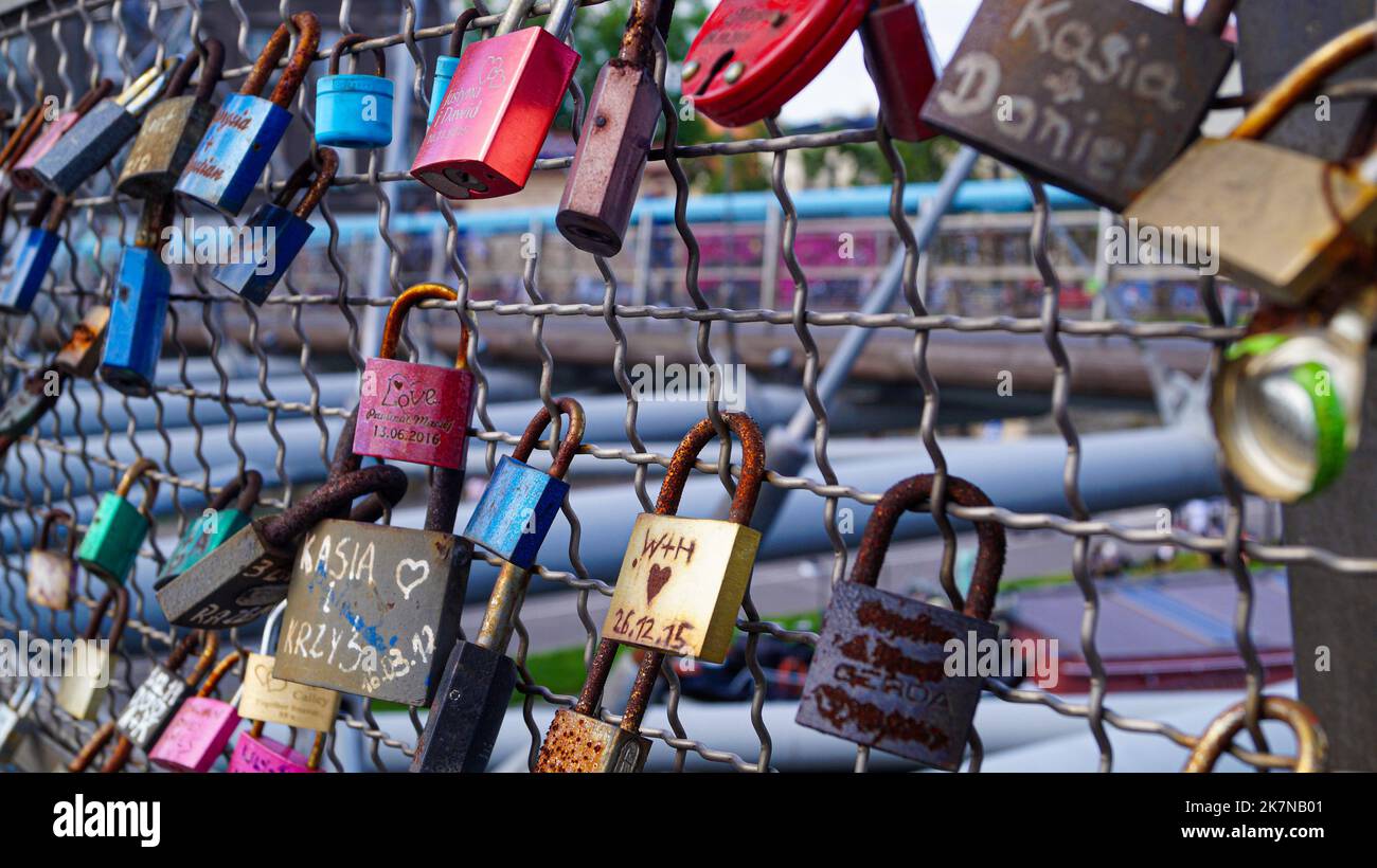 Love Lock Padlocks on Bridge with Lovers and friends initials on it in