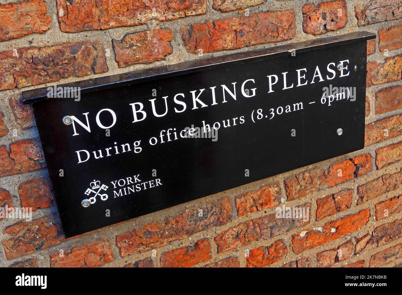No busking please, during working hours (8:30am - 6pm) sign, near York Minster, City of York, Yorkshire, England, UK, YO1 6GD Stock Photo