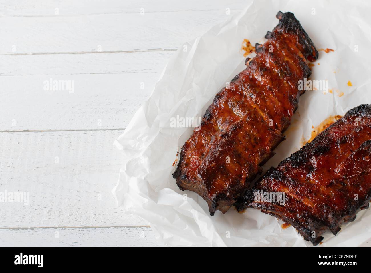 Barbecue pork ribs on white wooden background Stock Photo