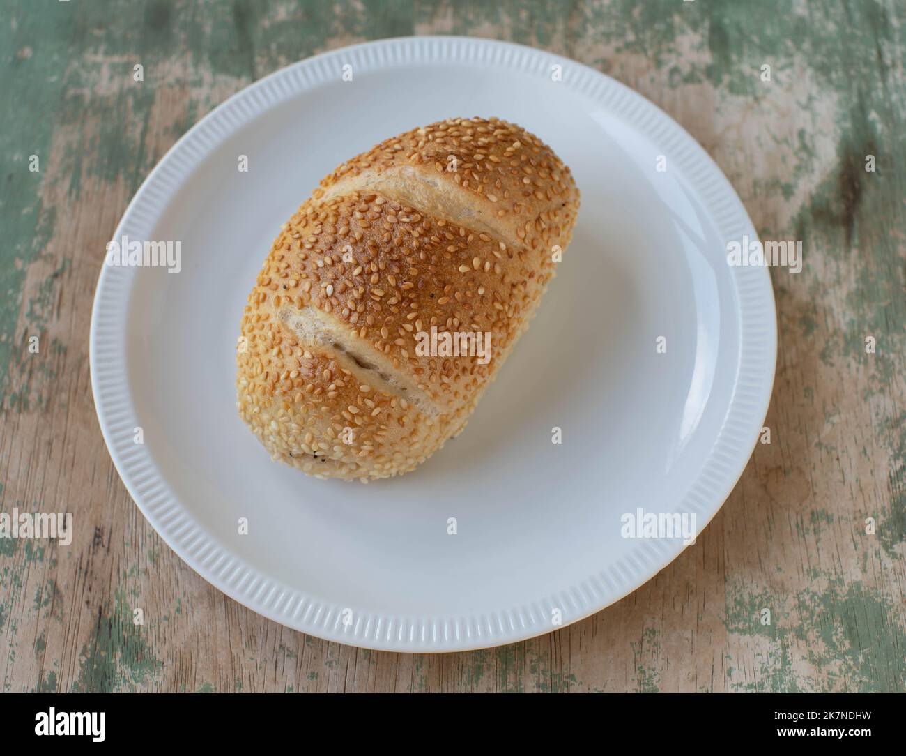 Sesame seed bun isolated on a plate Stock Photo Alamy