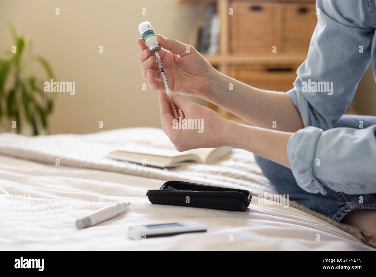 Woman with diabetes preparing insulin syringe on bed Stock Photo Alamy