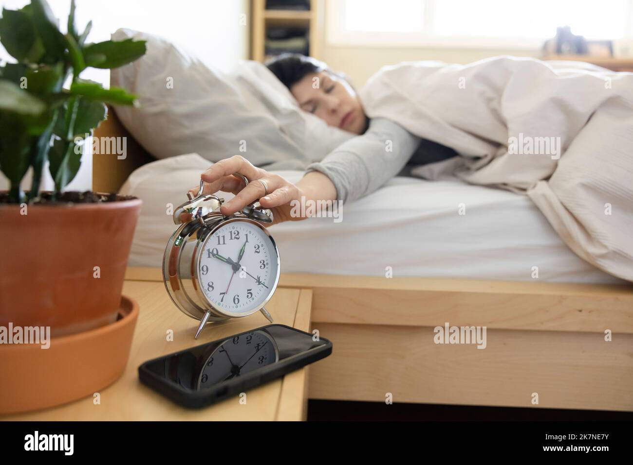 Mature woman snooze alarm clock hires stock photography and images Alamy