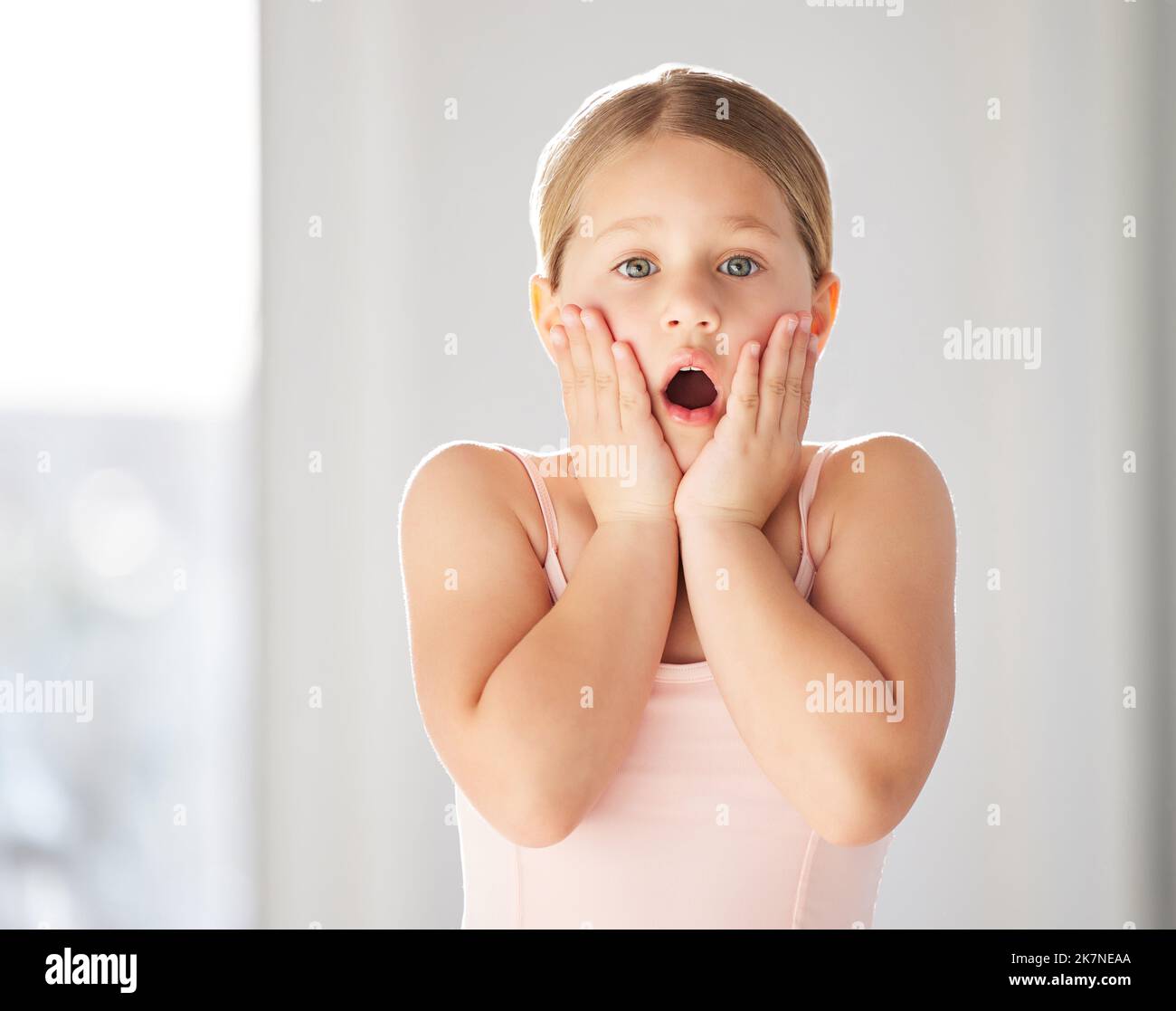 There are surprises around every corner. a little girl looking shocked in a dance studio. Stock Photo