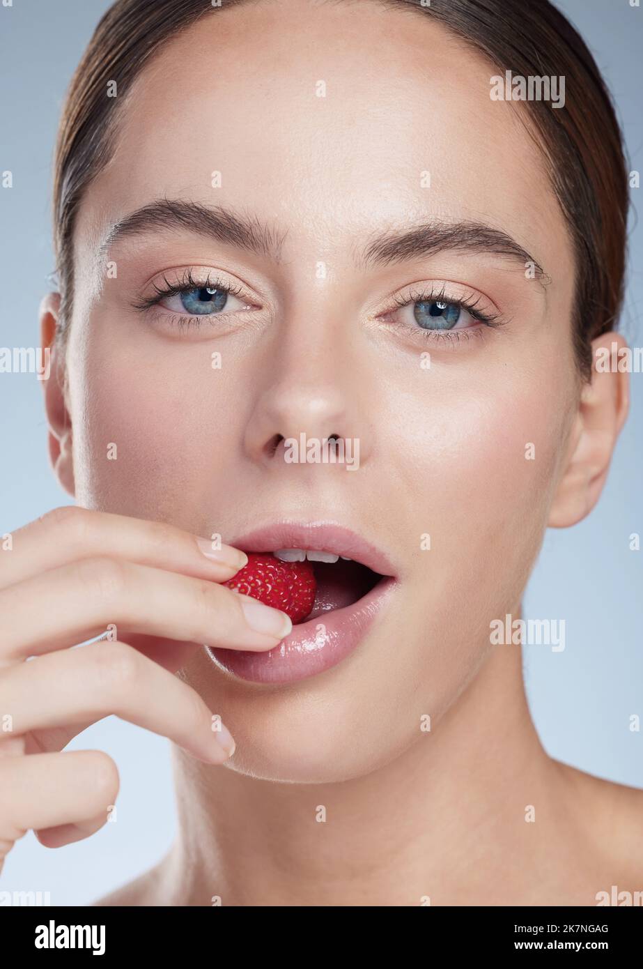 Young woman biting strawberry hi-res stock photography and images - Alamy
