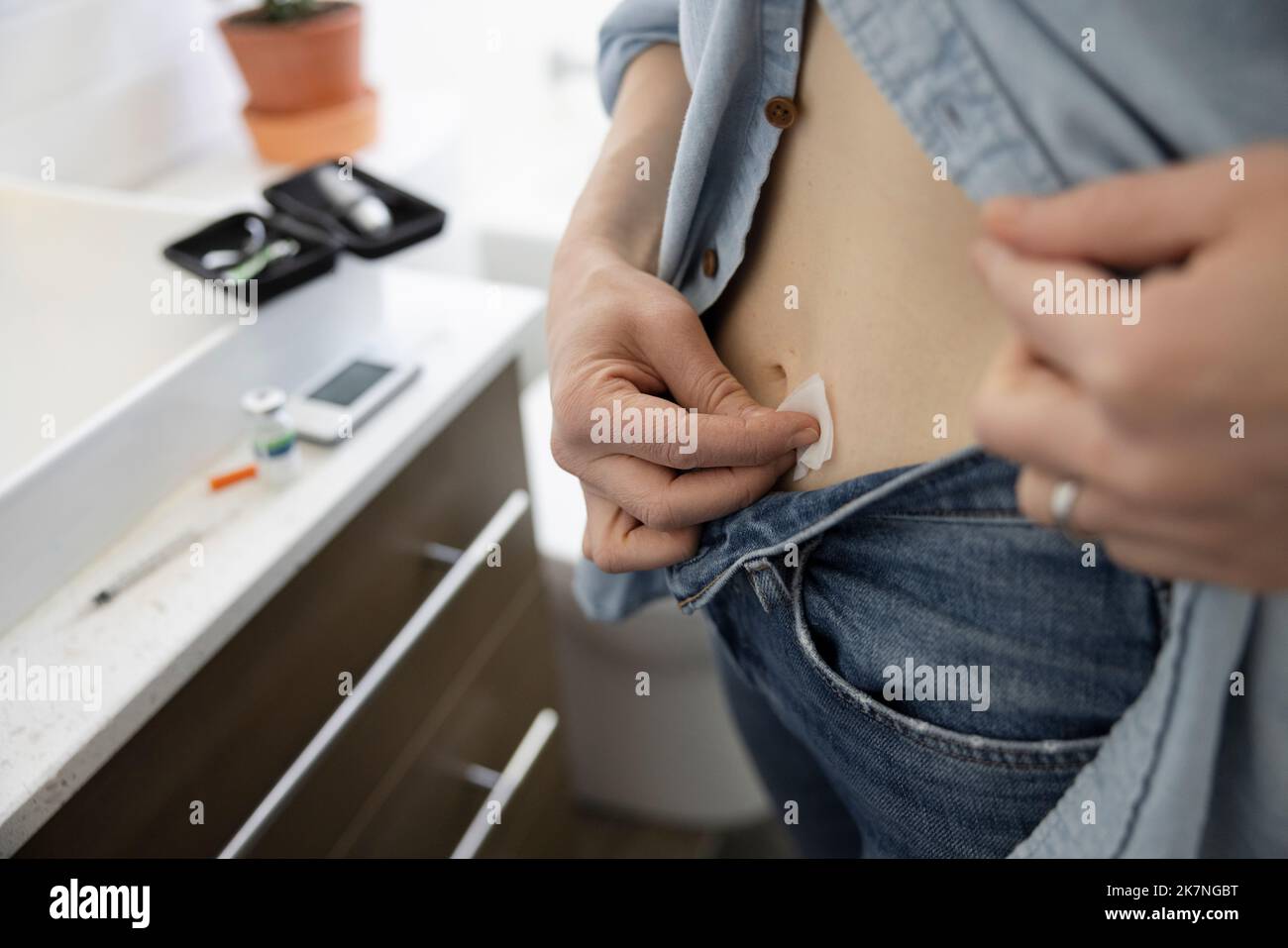Close up woman with diabetes preparing stomach for insulin injection