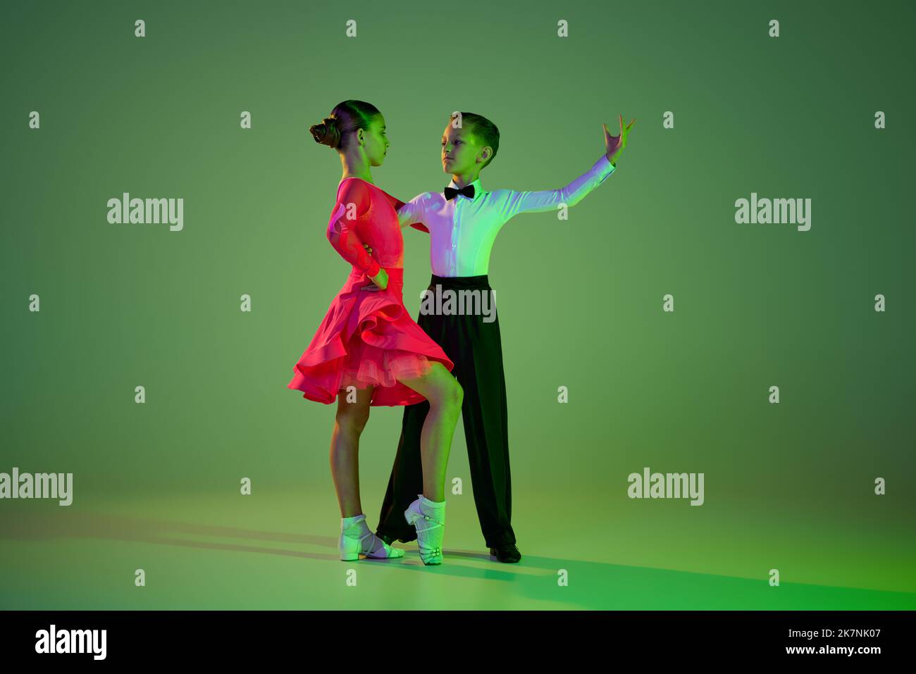 Cha cha cha, rumba, tango. Carming little boy and beautiful girl