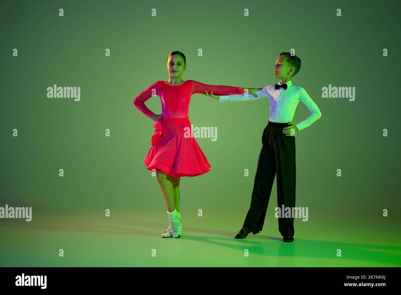 Beginner dancers. Portrait of beautiful little boy and girl dancing