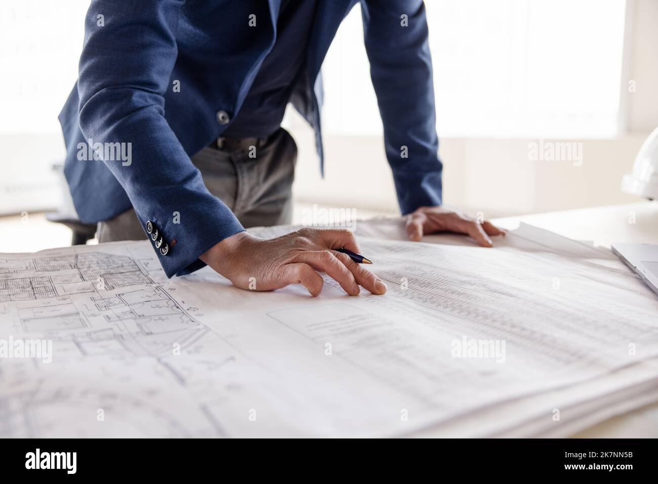 Man working on plan of building interior Stock Photo