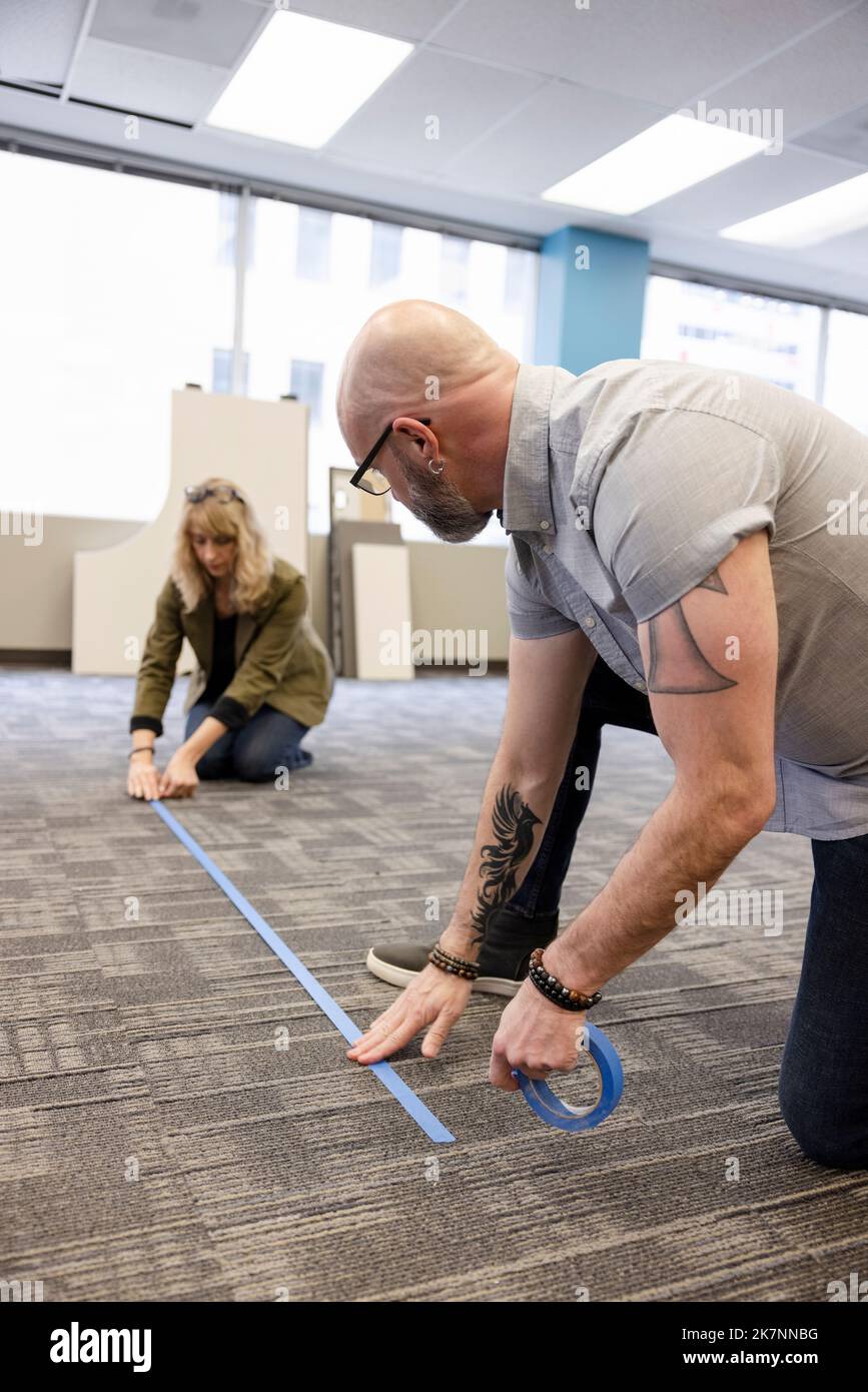 Business partners laying out floor plan for office remodel Stock Photo