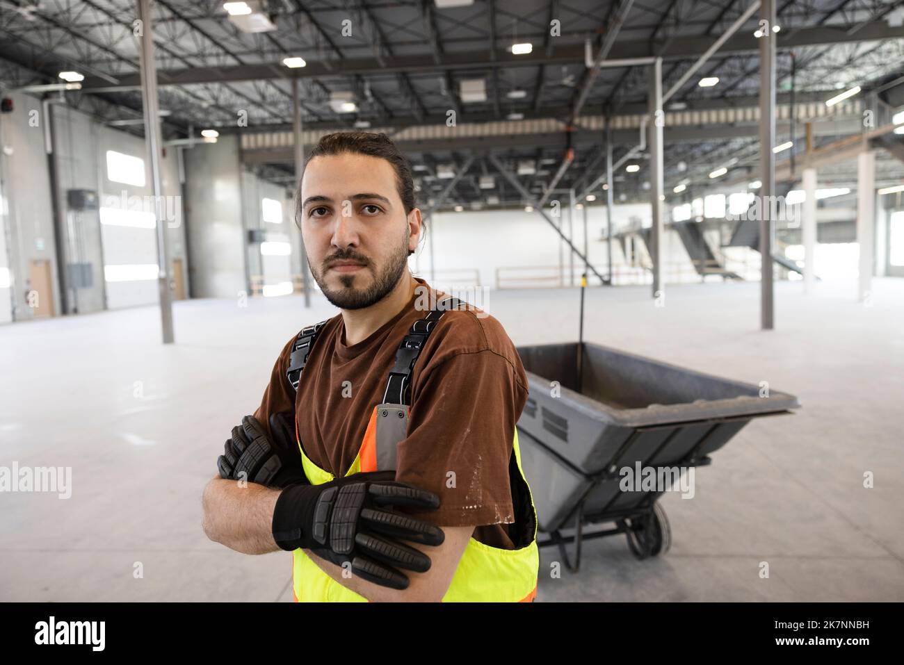 Portrait of worker cleaning empty warehouse Stock Photo - Alamy