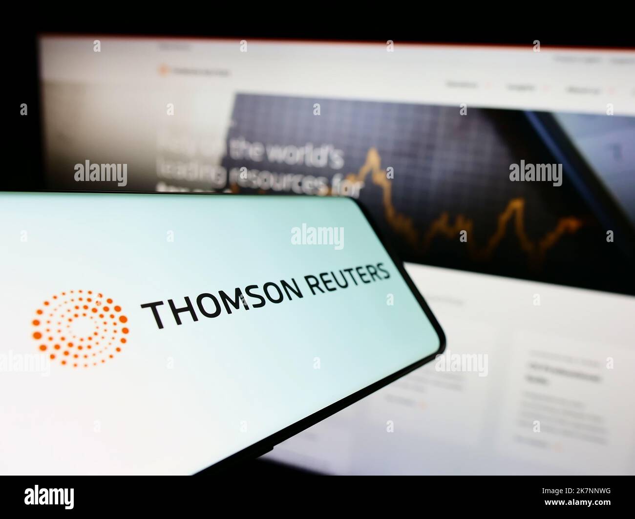 Smartphone with logo of Canadian media company Thomson Reuters Corporation on screen in front of website. Focus on center of phone display. Stock Photo