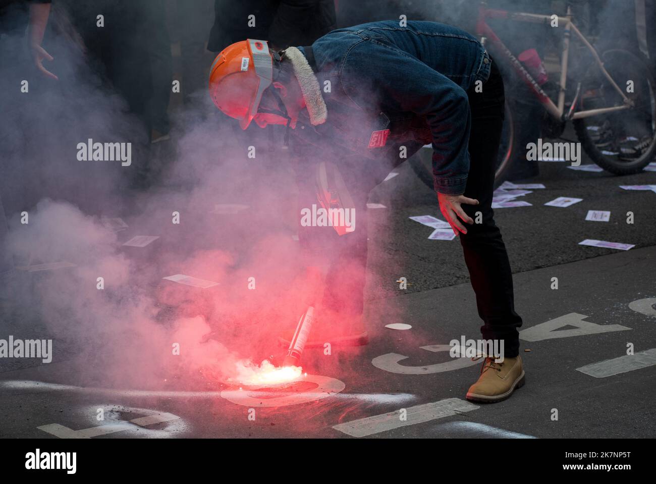 Paris, France, 18th October, 2022. Demonstration with a protester using sparkler during a national day of strike and protests for higher wages - Jacques Julien/Alamy Live News Stock Photo