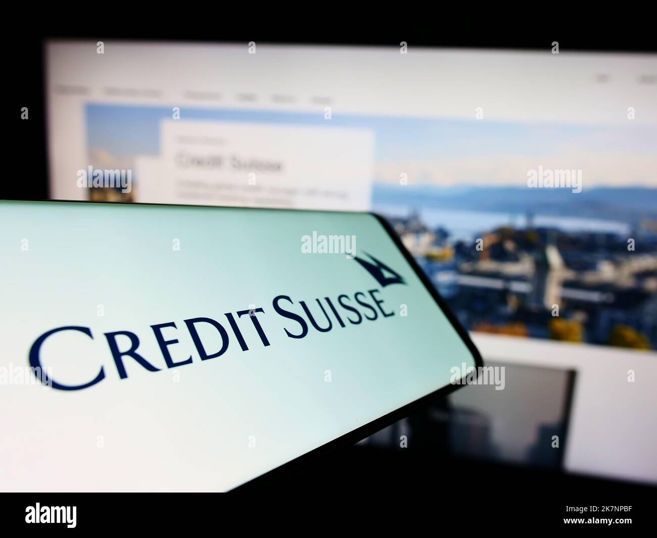 Smartphone with logo of Swiss financial company Credit Suisse Group AG on screen in front of business website. Focus on center of phone display. Stock Photo