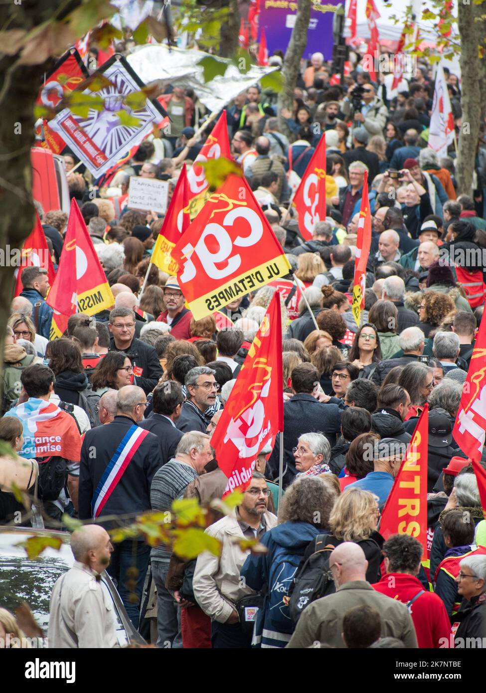 Paris, France, 18th October, 2022. Demonstrators march with CGT flags during a national day of strike and protests for higher wages - Jacques Julien/Alamy Live News Stock Photo