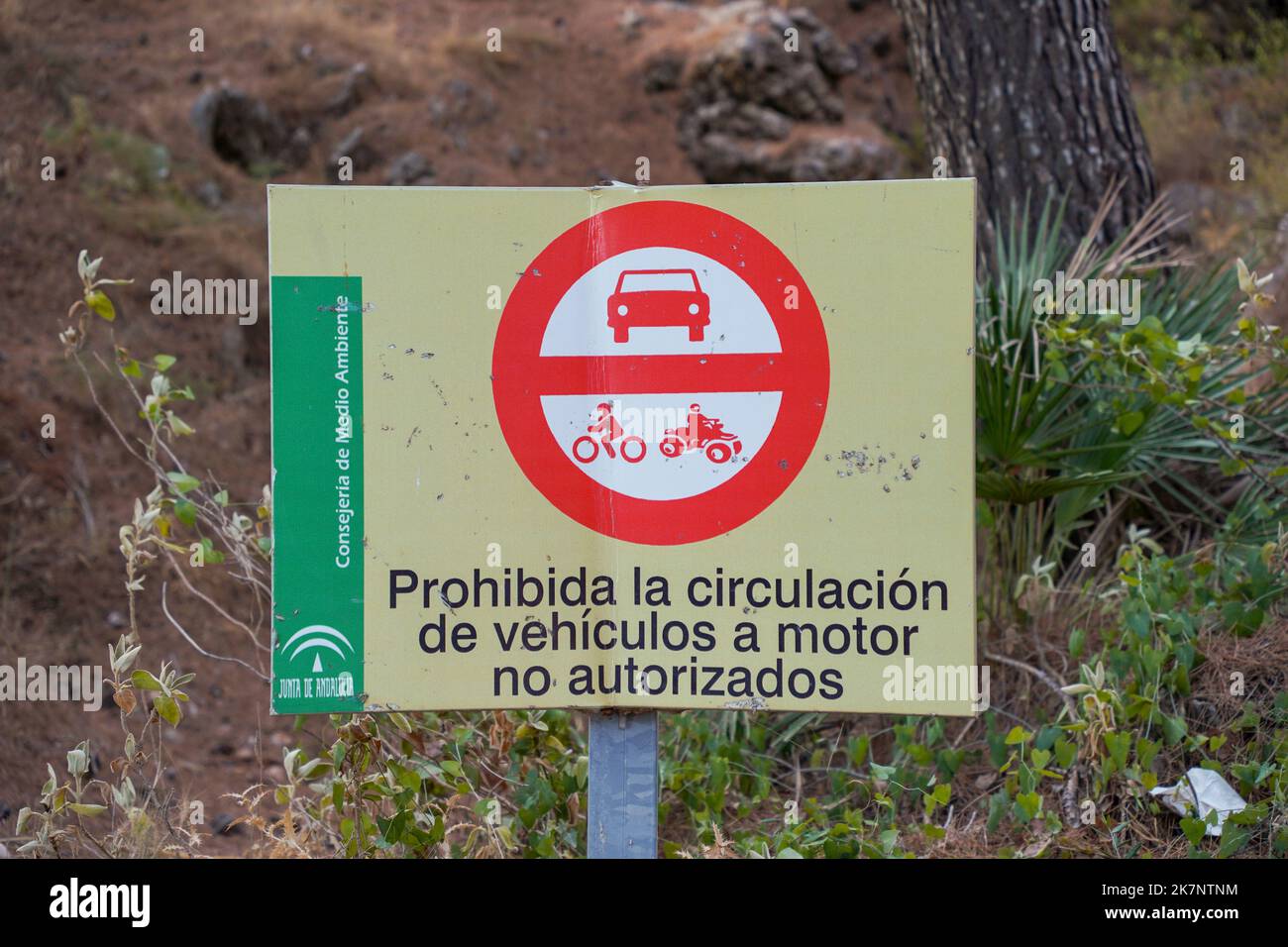Sign in spanish, no entrance motorised vehicles in mountain forest road. Spain. Stock Photo