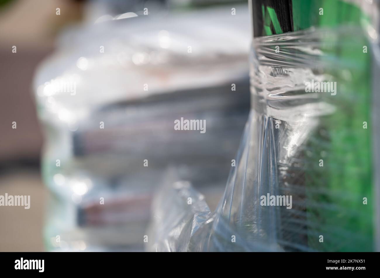 Selective focus on cellophane shrink wrap on pallets of goods for