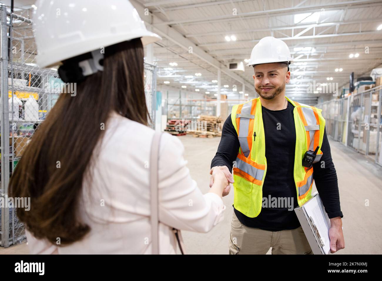 Man and women shaking hands hard hat hires stock photography and