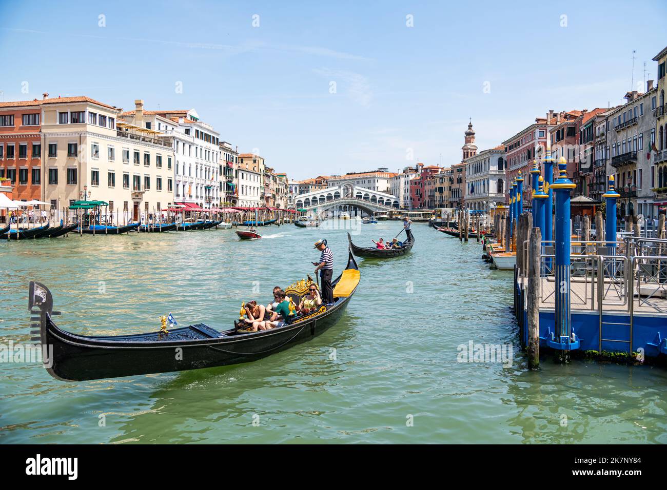 A tourist family exploring the Grand Canal in a gondola in Venice ...