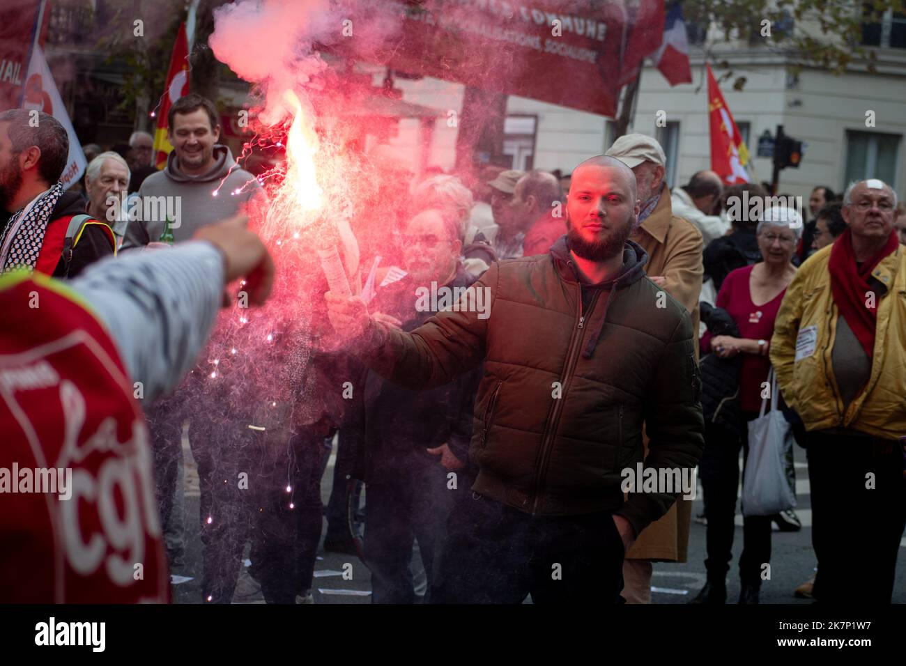 Paris, France, 18th October, 2022. Demonstration march with young man with sparkler during a national day of strike and protests for higher wages - Jacques Julien/Alamy Live News Stock Photo