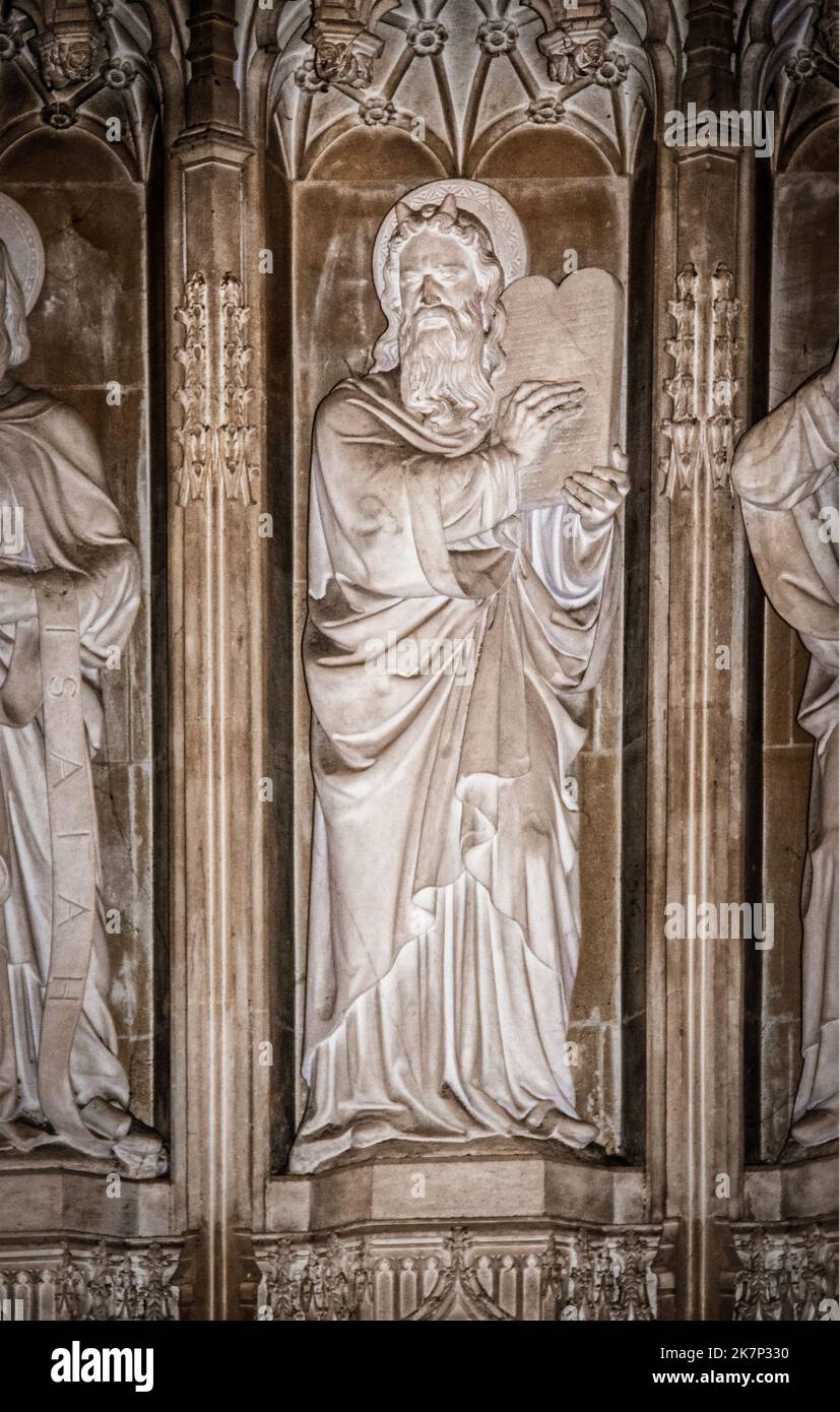 07-07-2019 Oxford, England - Sculpture-relief of normal medieval Western depiction of horned Moses holding tablets in Chapel at New College Stock Photo