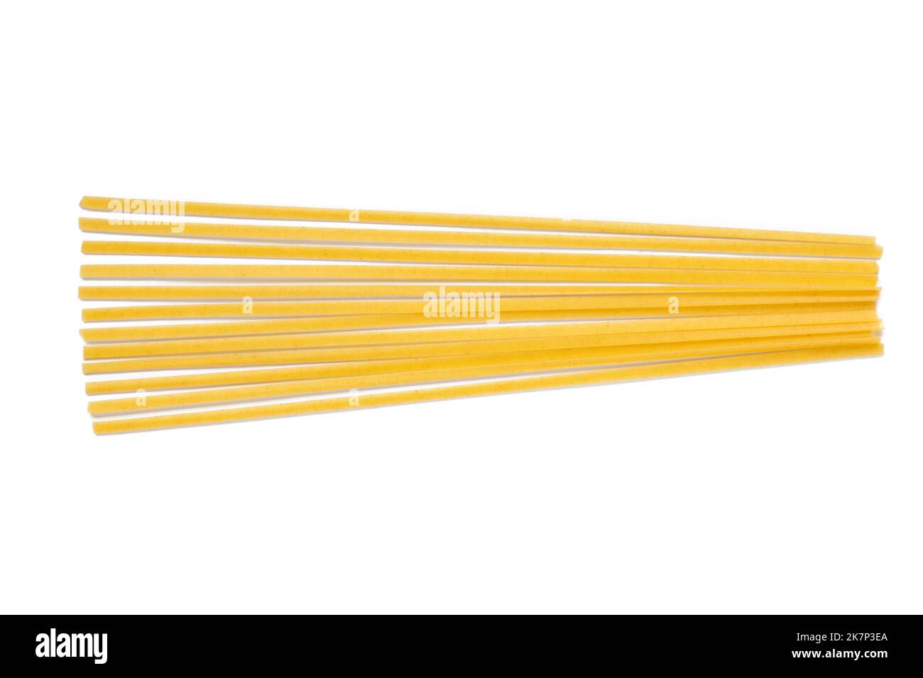 Pile of uncooked dry durum fettuccine pasta isolated on white background. Raw spaghetti or