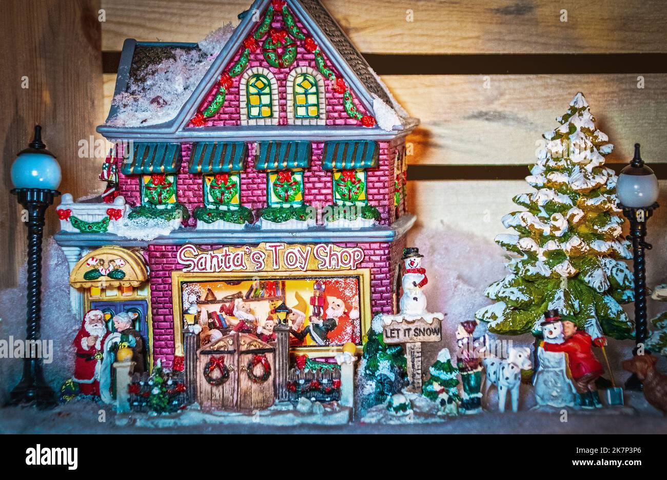 Scene from Christmas Village with Santas Toy Shope and kids and dogs outside in snow - focus on the building Stock Photo
