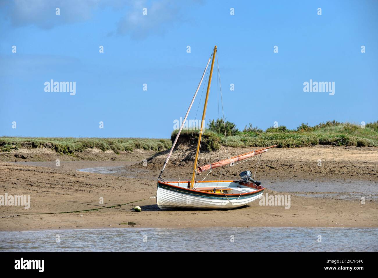 Burnham Overy Staithe, Norfolk, UK, boat at low tide in the harbour Stock Photo