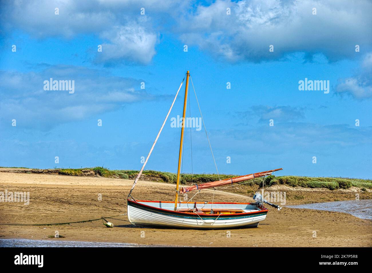 Burnham Overy Staithe, Norfolk, UK, boat at low tide in the harbour Stock Photo