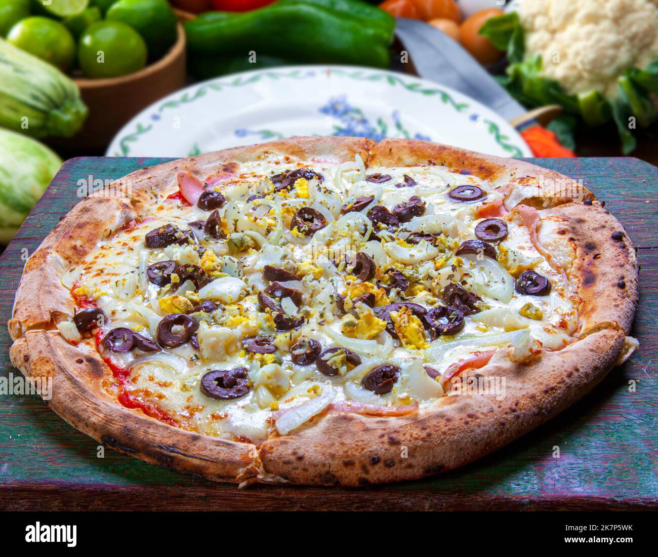 Pizza with bacon, chili, onion, pea, oliva Stock Photo