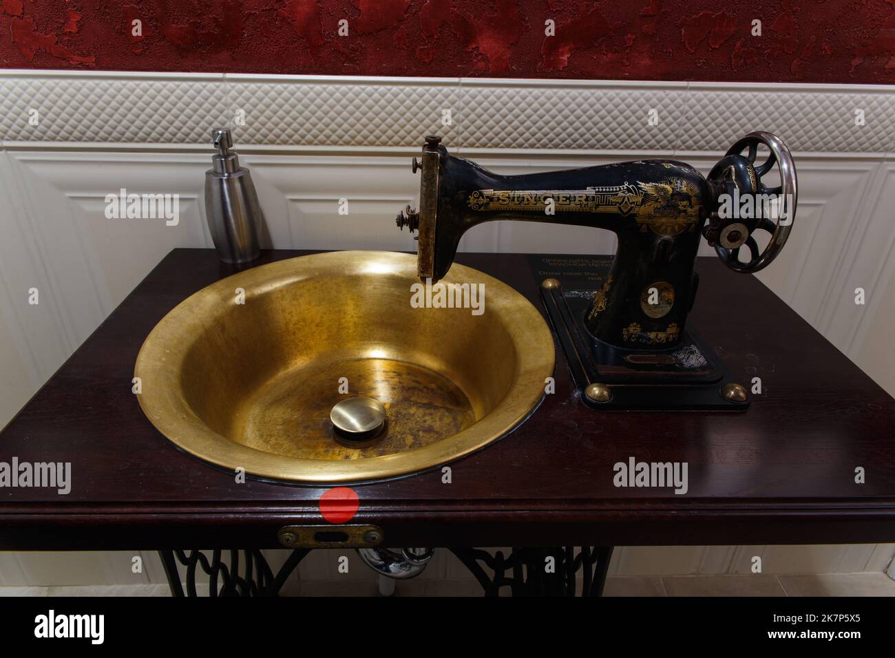 Grodno, Belarus - October 13, 2017: A washbasin made from an old Singer sewing machine in the Faraday bar. The water turns on automatically when the h Stock Photo