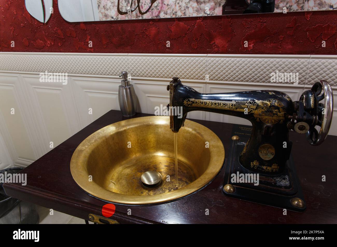 Grodno, Belarus - October 13, 2017: A washbasin made from an old Singer sewing machine in the Faraday bar. The water turns on automatically when the h Stock Photo