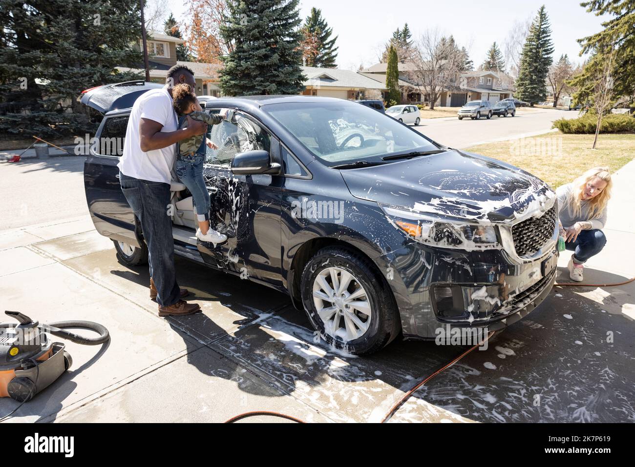 Family washing car in driveway Stock Photo Alamy