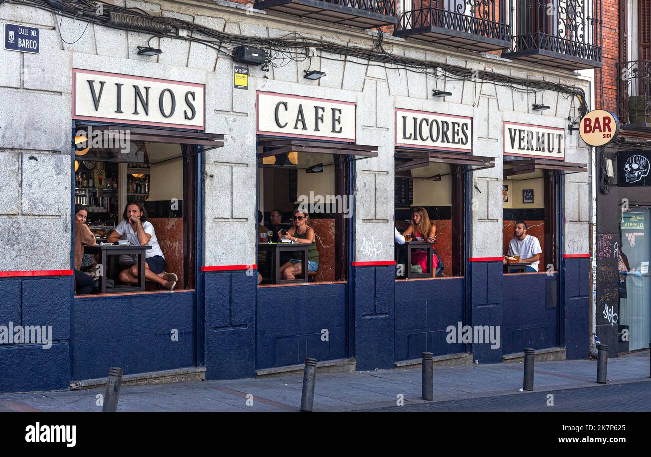 Customers seen through windows on lateral facade of Bar Sidi, Calle del Barco, Madrid, Spain. Stock Photo