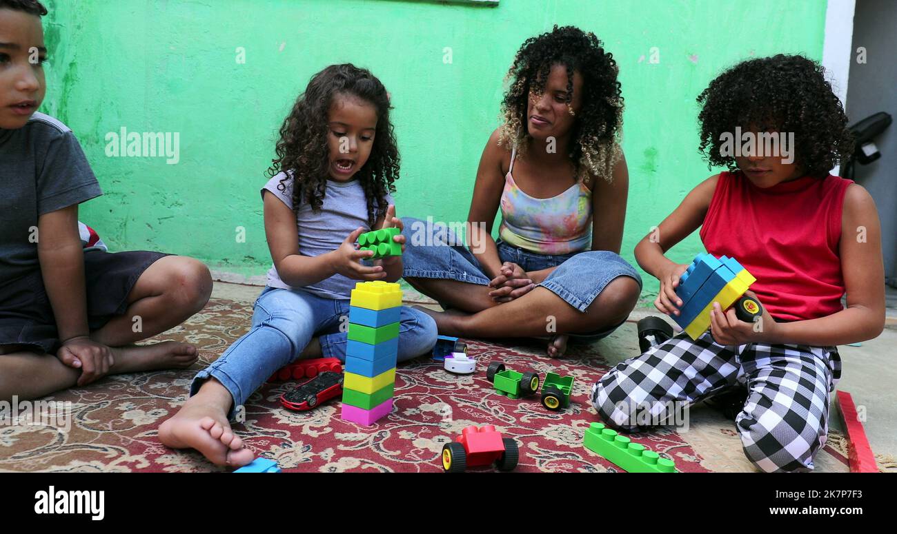 Hispanic children from south america playing with toys at backyard2